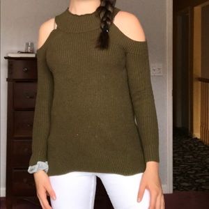 A green off the shoulder sweater